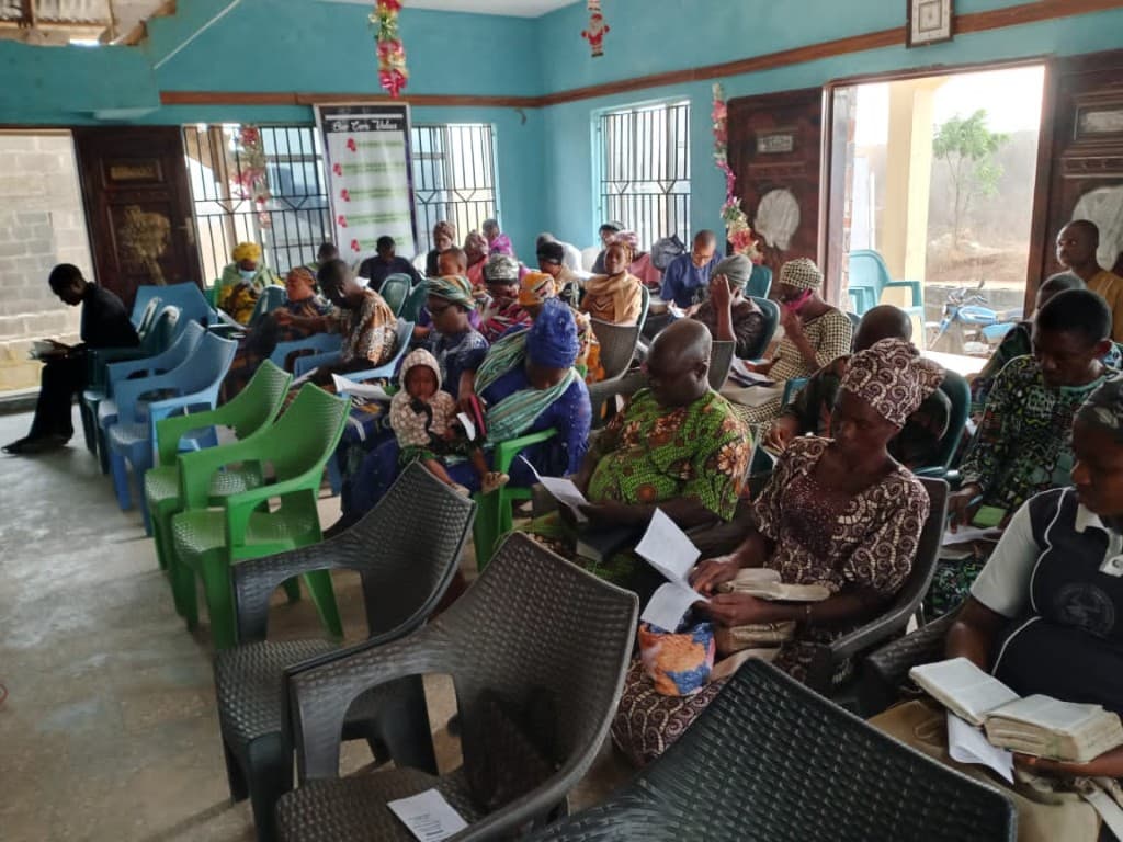 Congregation seated in worship, reading the Word together